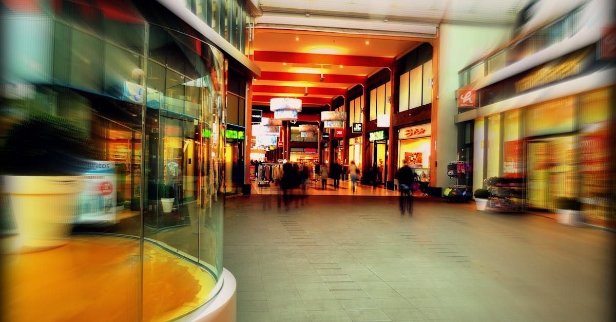 A blurry picture of a shopping mall with people walking through it.