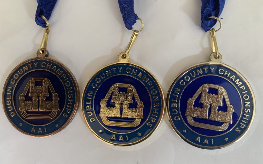 Three medals that say dublin county championship on them