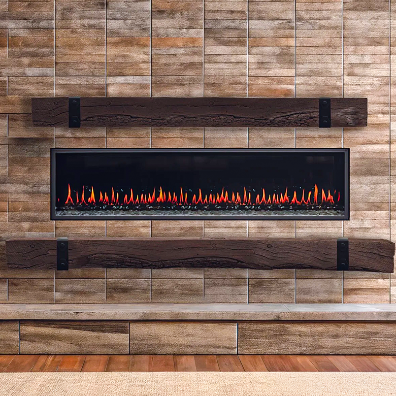 A fireplace with a stone surround, bench, and burning fire, beside a wooden cabinet and couch in a home.