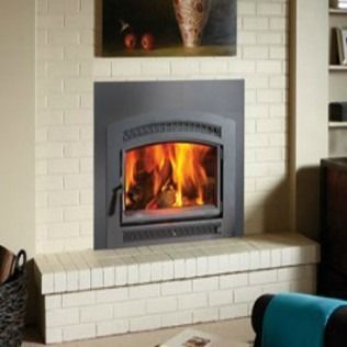 Fireplace insert with burning flames, set in white brick.