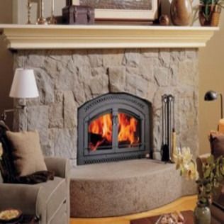Stone fireplace with flames, mantel, and seating.