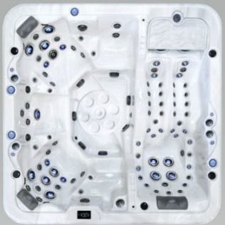 Top-down view of a white hot tub with multiple jet configurations and seating areas.