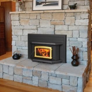Fireplace with stone surround and a pellet stove with a glowing fire.