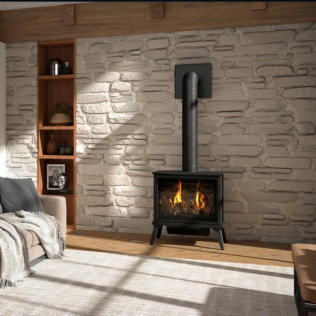 Gas fireplace in a stone-walled living room with a built-in bookcase and wooden beams.