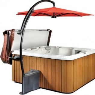 Hot tub with cover, red umbrella, and wood paneling.