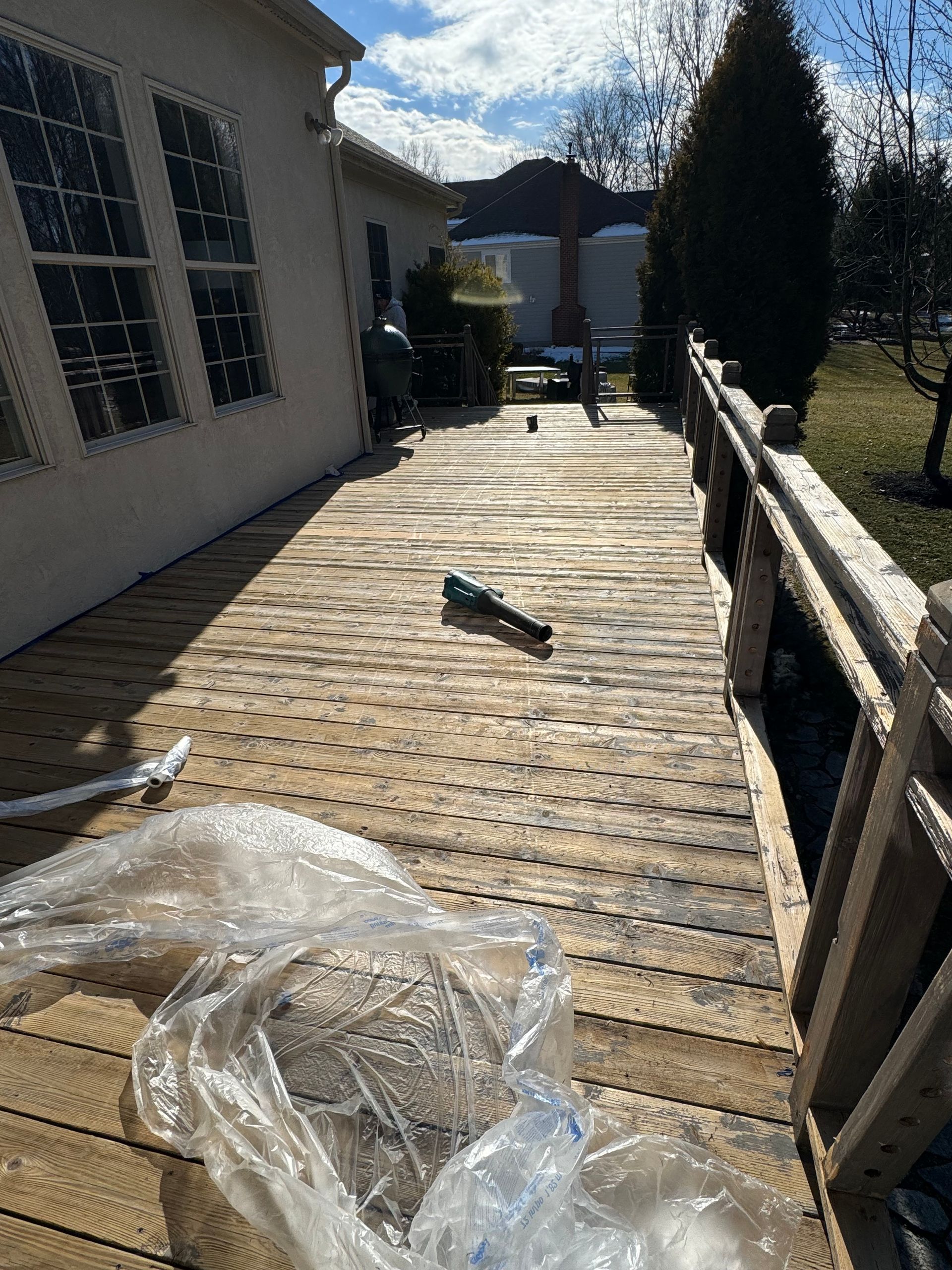 A wooden deck is being built in front of a house.