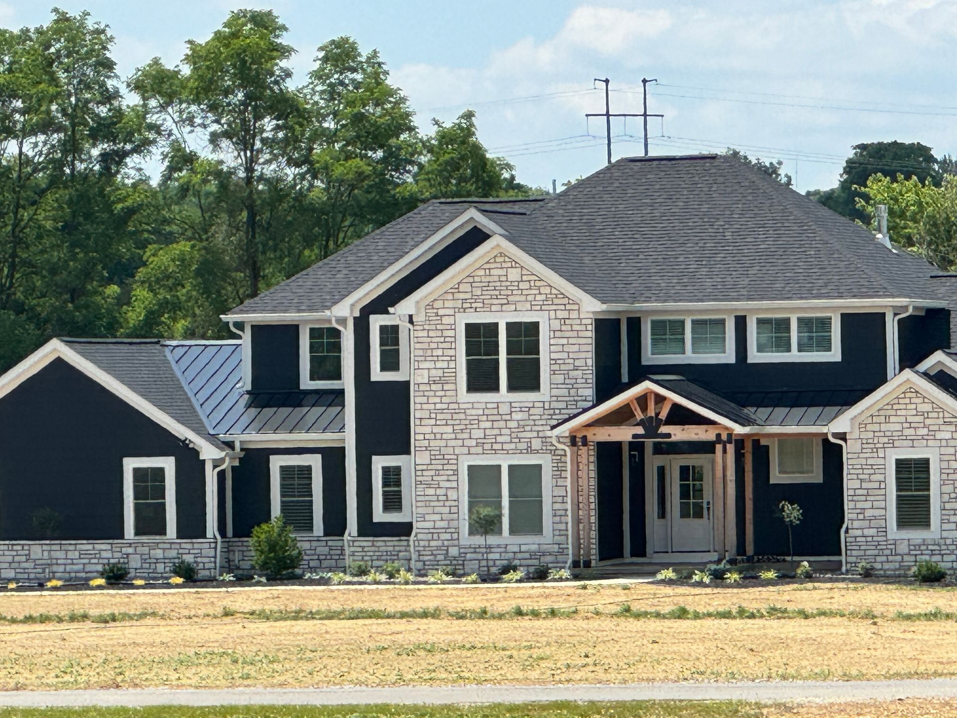 A large house with a roof that has a cross on it