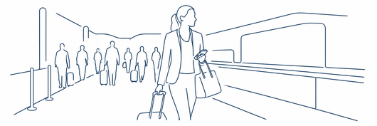 Voetgangers lopen door een moderne stationsgang met leuningen en bewegwijzering boven hun hoofden.