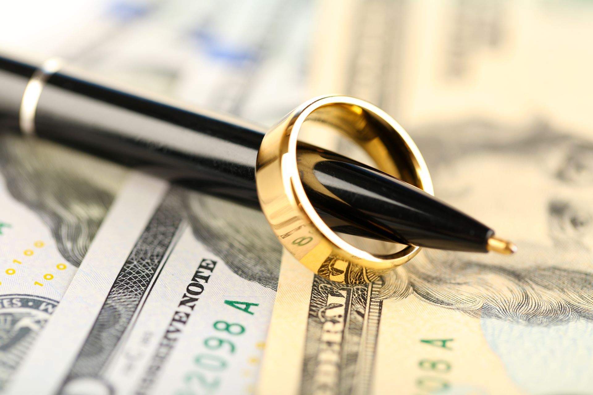 A pen with a wedding ring on top of it