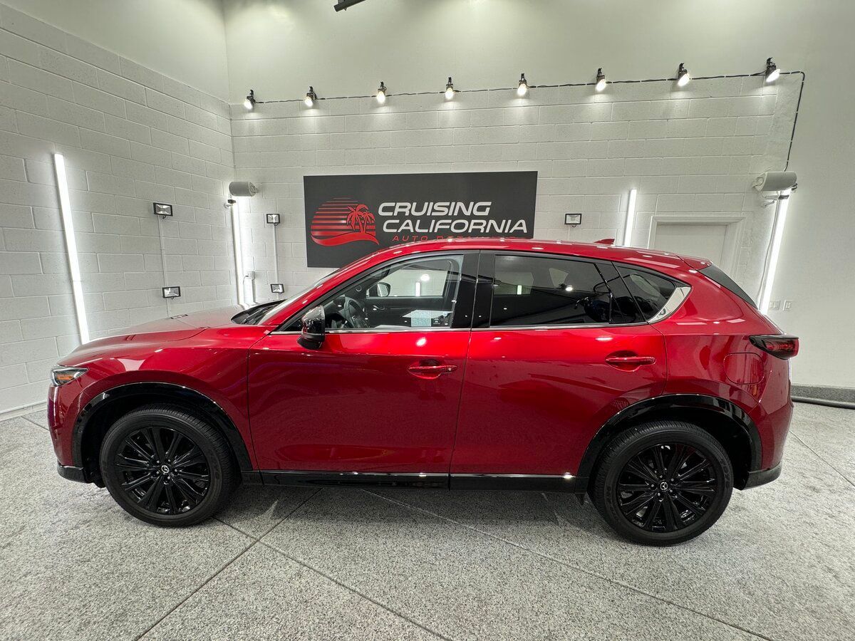A red mazda cx-5 is parked in a showroom.