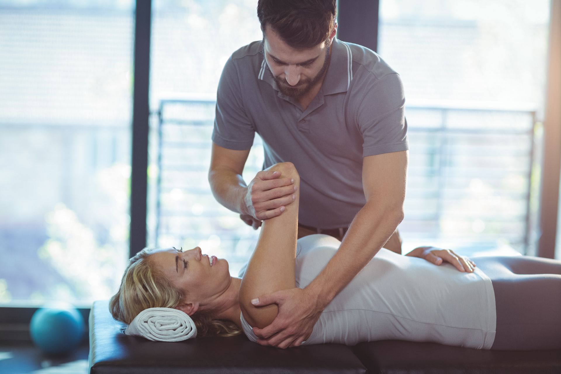 Physical therapist treats woman's arm. Physical therapist treats woman's arm.