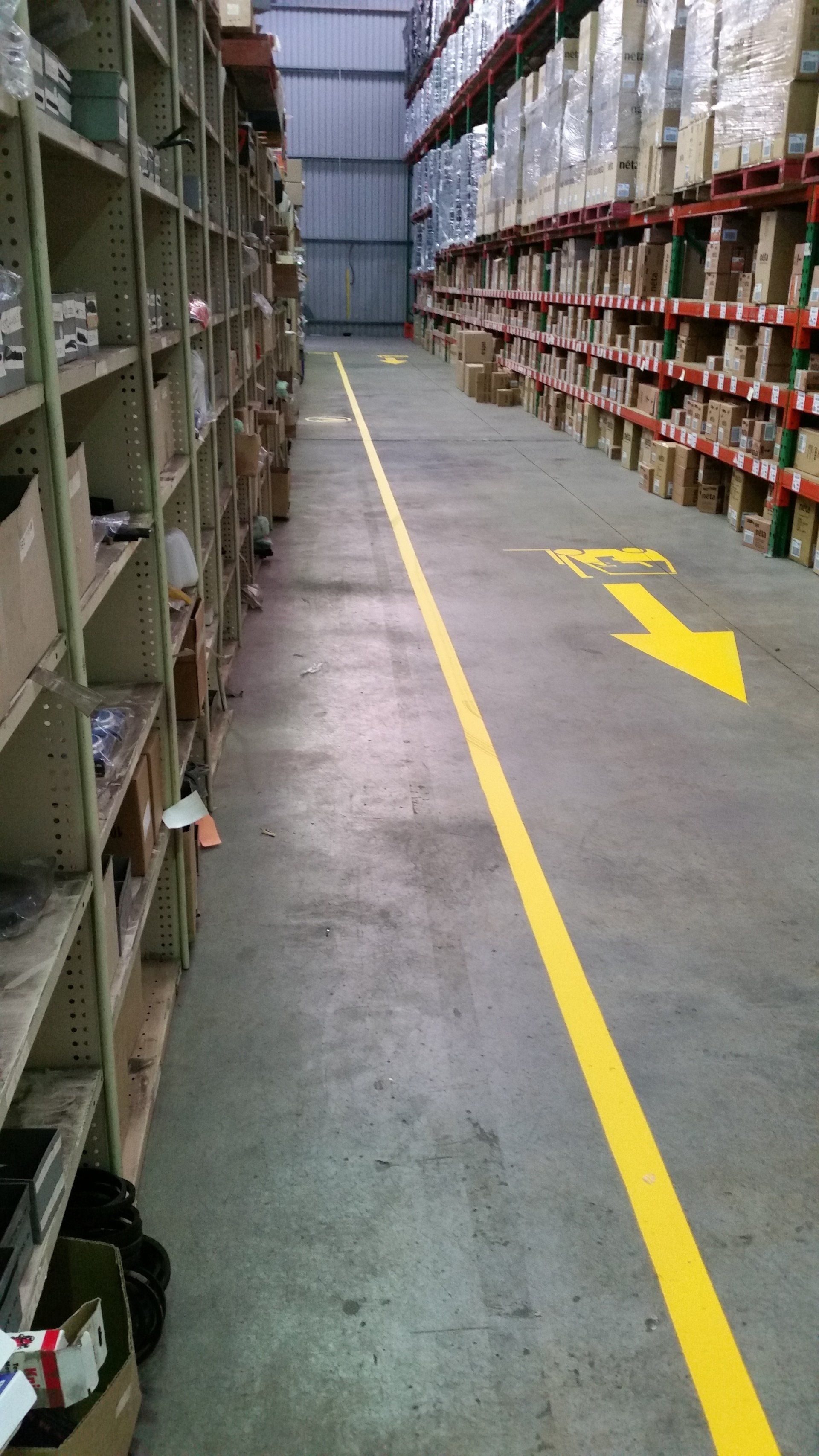 Warehouse Aisle with Yellow Line Marking