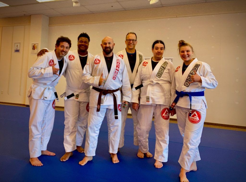 A group of people in karate uniforms are posing for a picture.