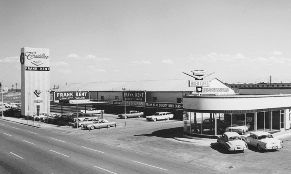 An aged photo of trucks on a city street