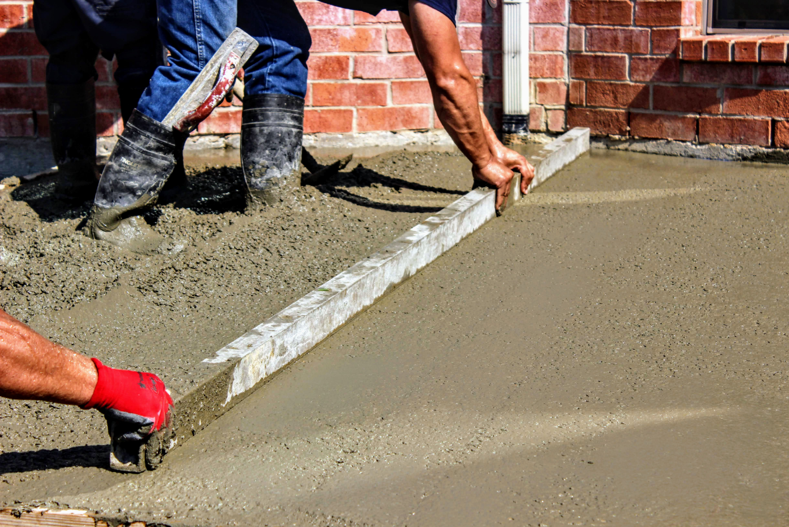 Concrete contractors working on building a concrete driveway.