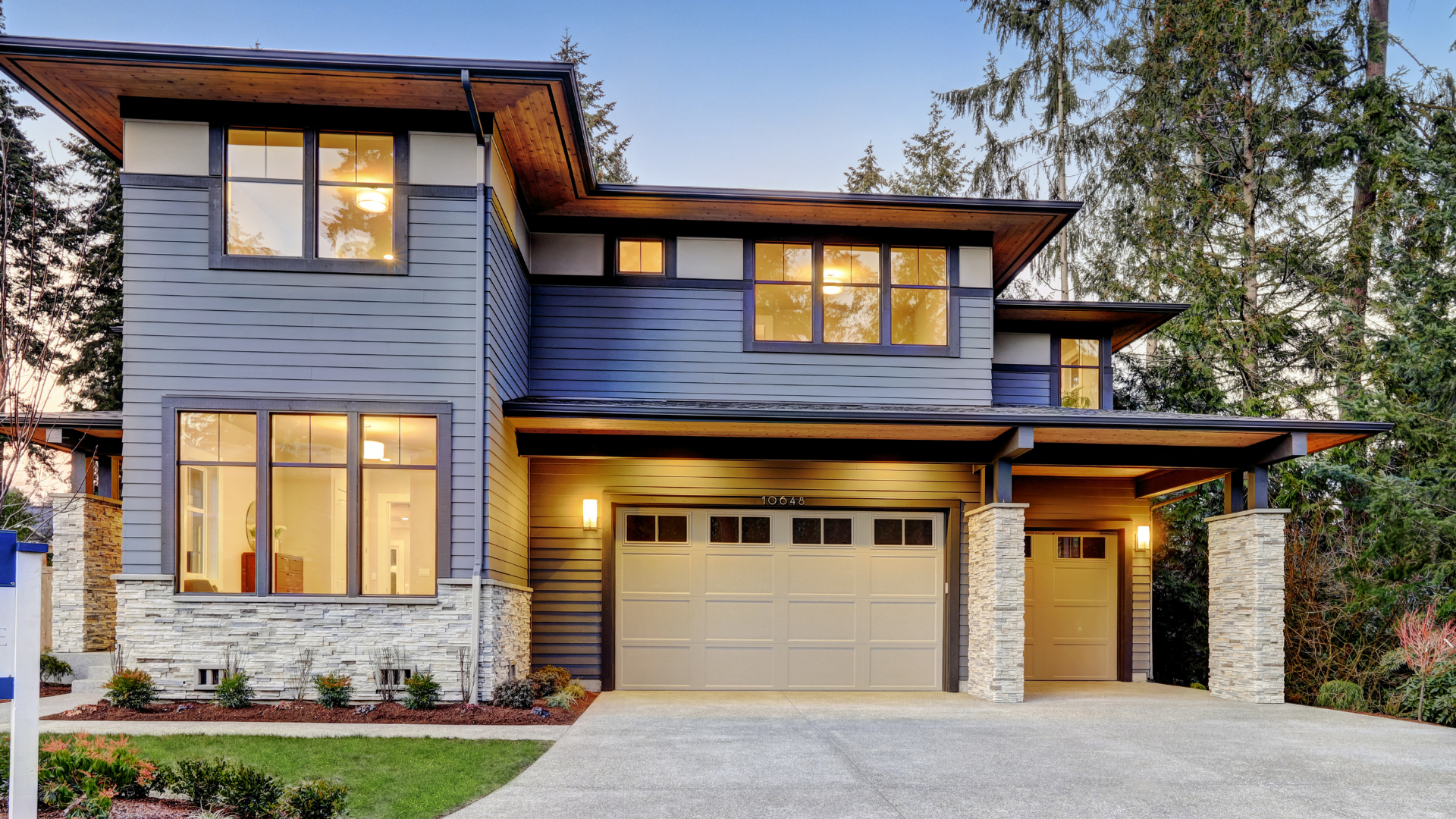Picture of a concrete driveway in front of a new build modern house.