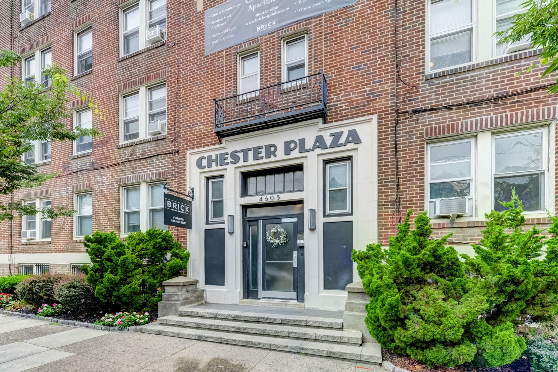 Photo of an entrance to a building with a few gentle steps leading up to the entrance.