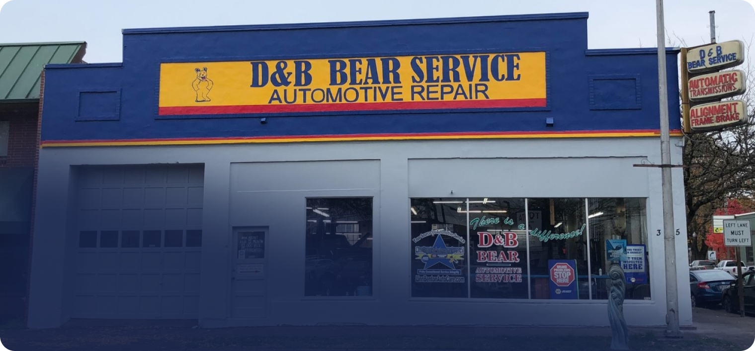 A blue and yellow sign for d & b bear service automotive repair | D & B Bear Service