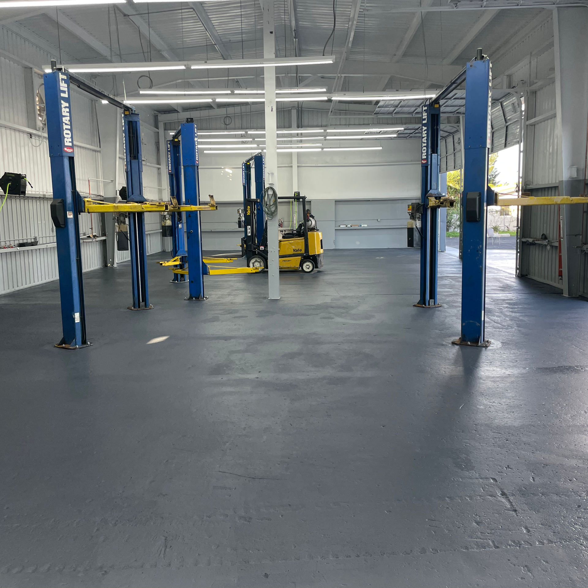 Clean And Organized Automotive Repair Bays With Vehicle Lifts | New Era Automotive