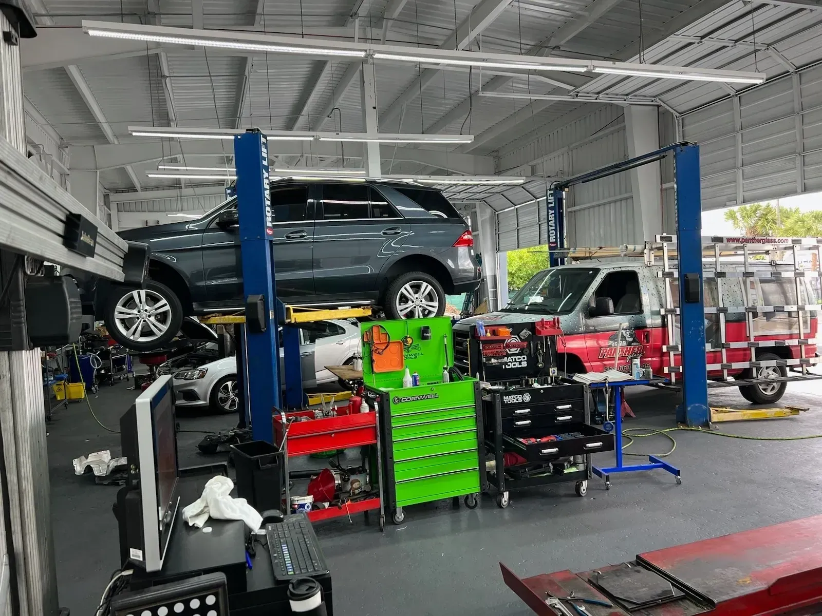 Full Service Auto Repair Shop With Vehicle On Lift And Tools | New Era Automotive