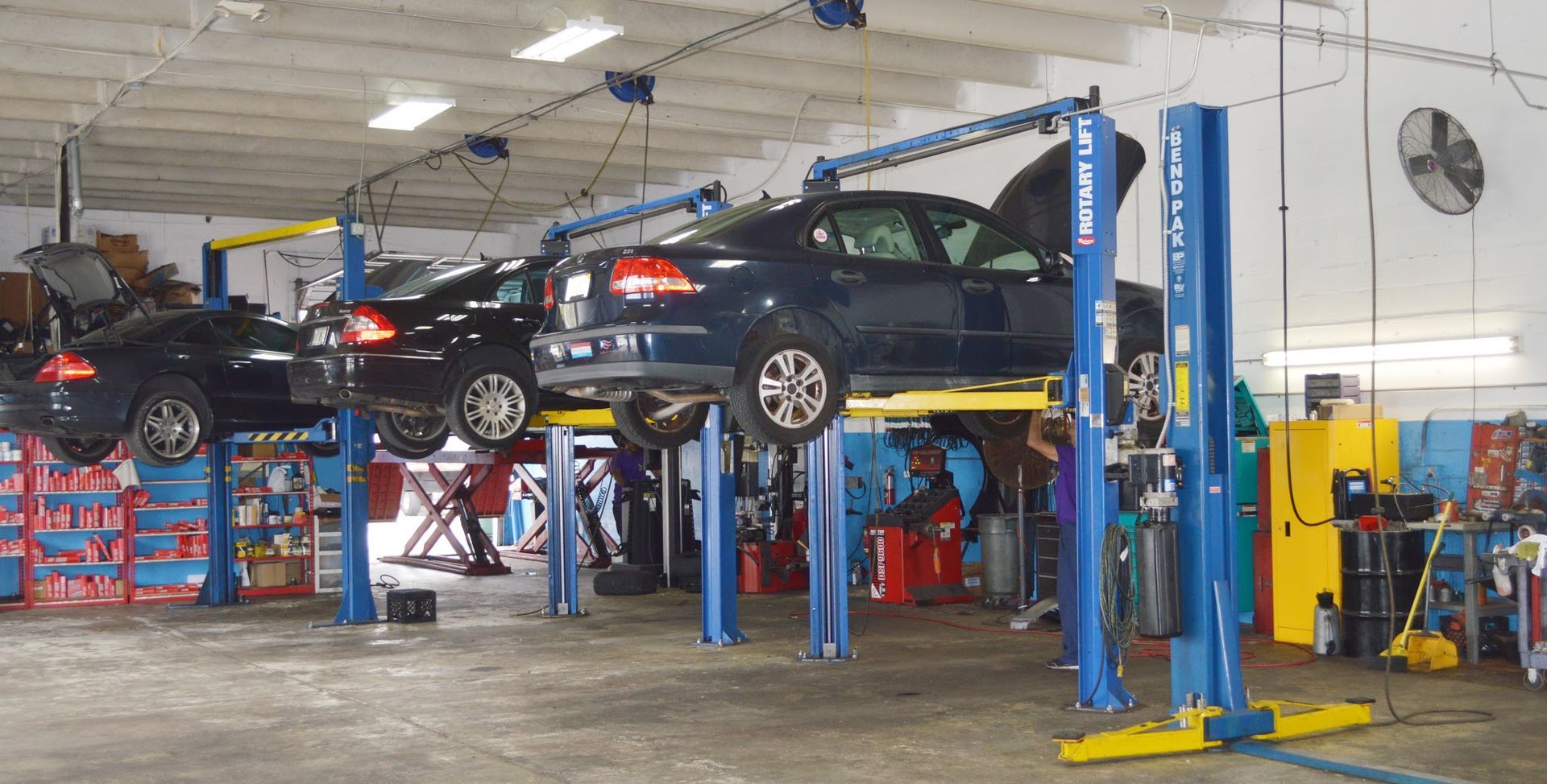 Full Service Auto Repair Shop With Vehicles On Hydraulic Lifts | New Era Automotive