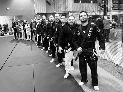 A man wearing a black shirt that says jiu jitsu on it