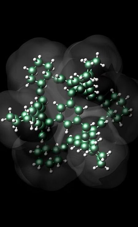 Dark molecular model with green atoms and gray translucent surfaces on a black background