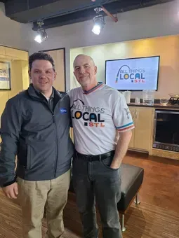 Two men standing in a studio, smiling beside a screen that says “The Local List.” | Quality Auto Repair Tire & Auto Sales
