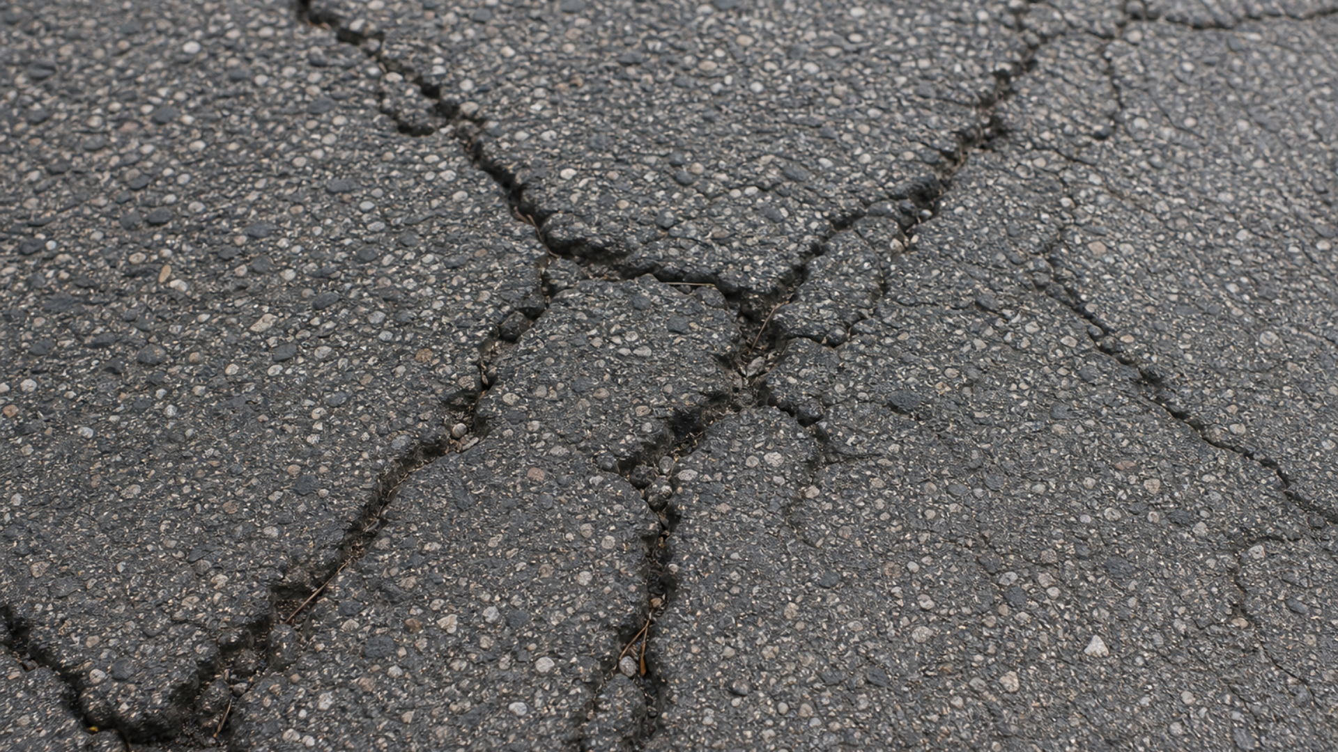 asphalt damage before driveway resurfacing