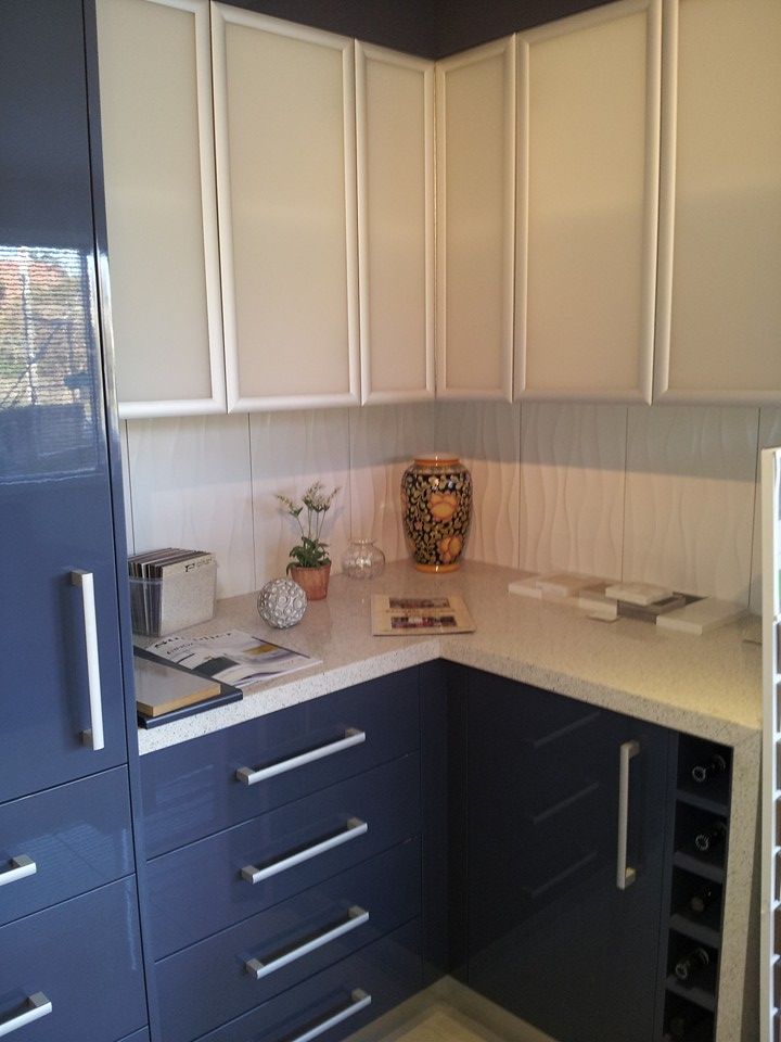 A Kitchen with Blue Cabinets and White Counter Tops — Custom Cabinetry & Kitchen Renovations in Woolgoolga, NSW