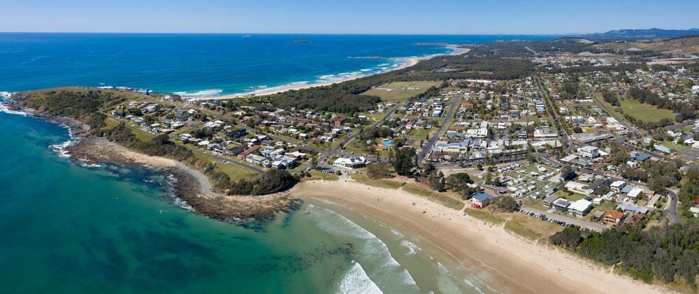 An Aerial View of A Beach with A City in The Background — Custom Cabinetry & Kitchen Renovations in Woolgoolga, NSW