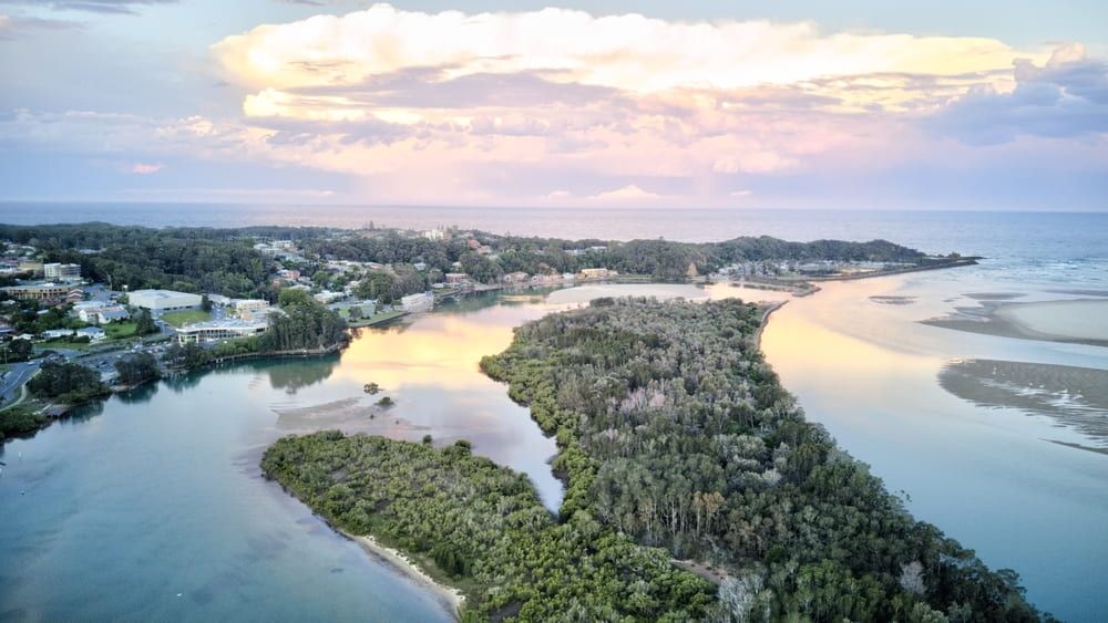 An Aerial View of A River with A Small Island in The Middle of It — Custom Cabinetry & Kitchen Renovations in Nambucca Heads, NSW