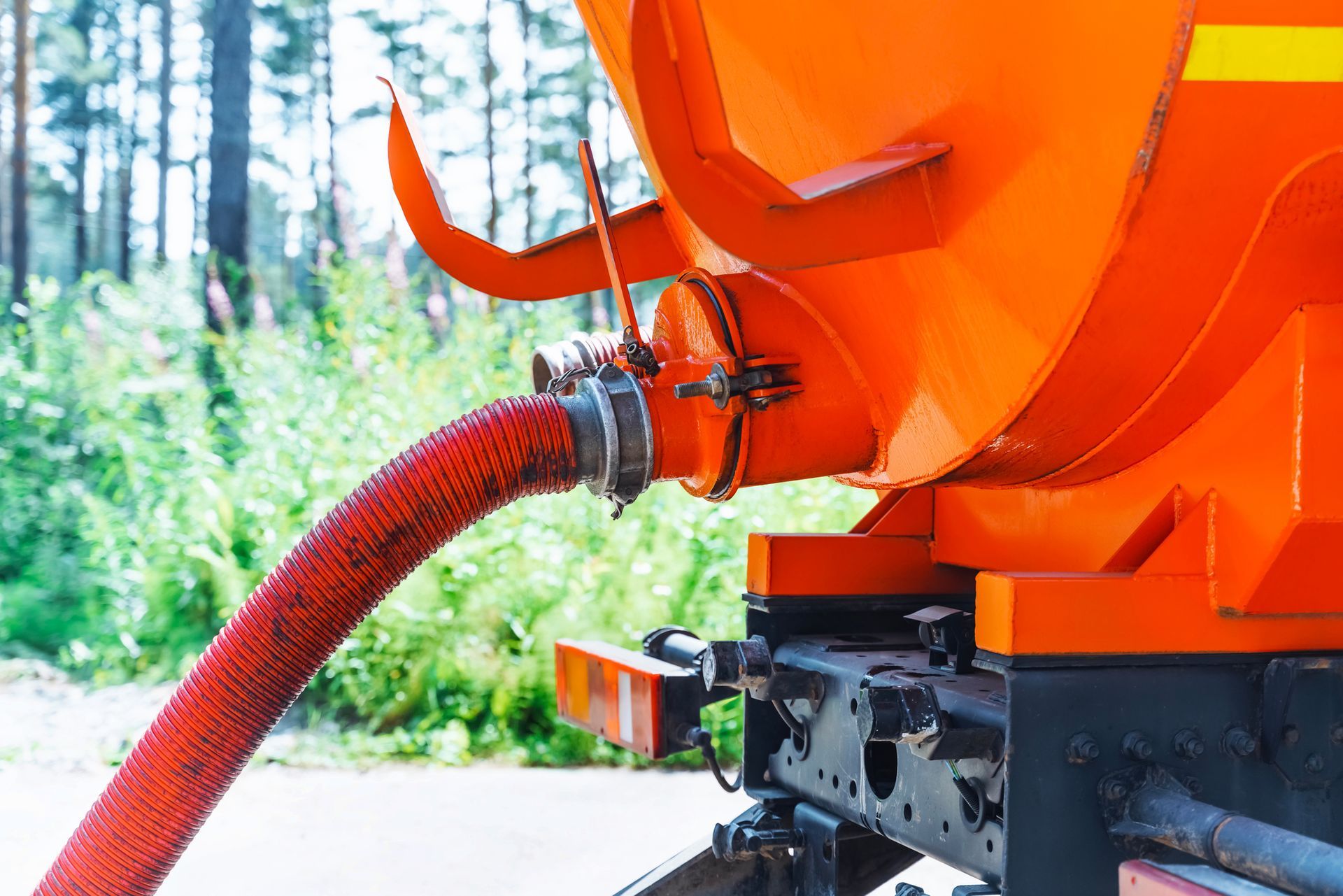 Pumping out sewage from a septic tank.