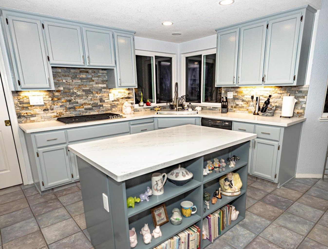 A kitchen with a large island in the middle of it.