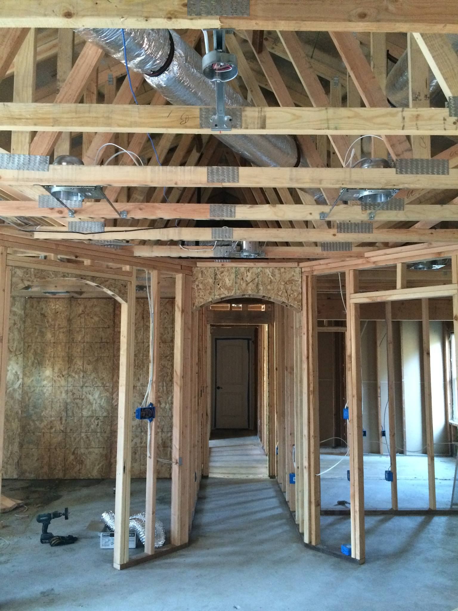 A house is being built with a lot of wooden beams.