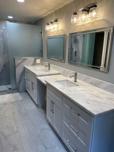 A bathroom with two sinks and two mirrors.