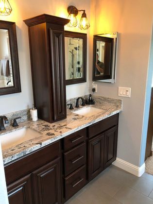 A bathroom with two sinks and two mirrors.