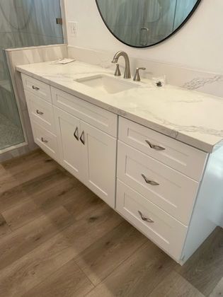 A bathroom vanity with a sink and a mirror.