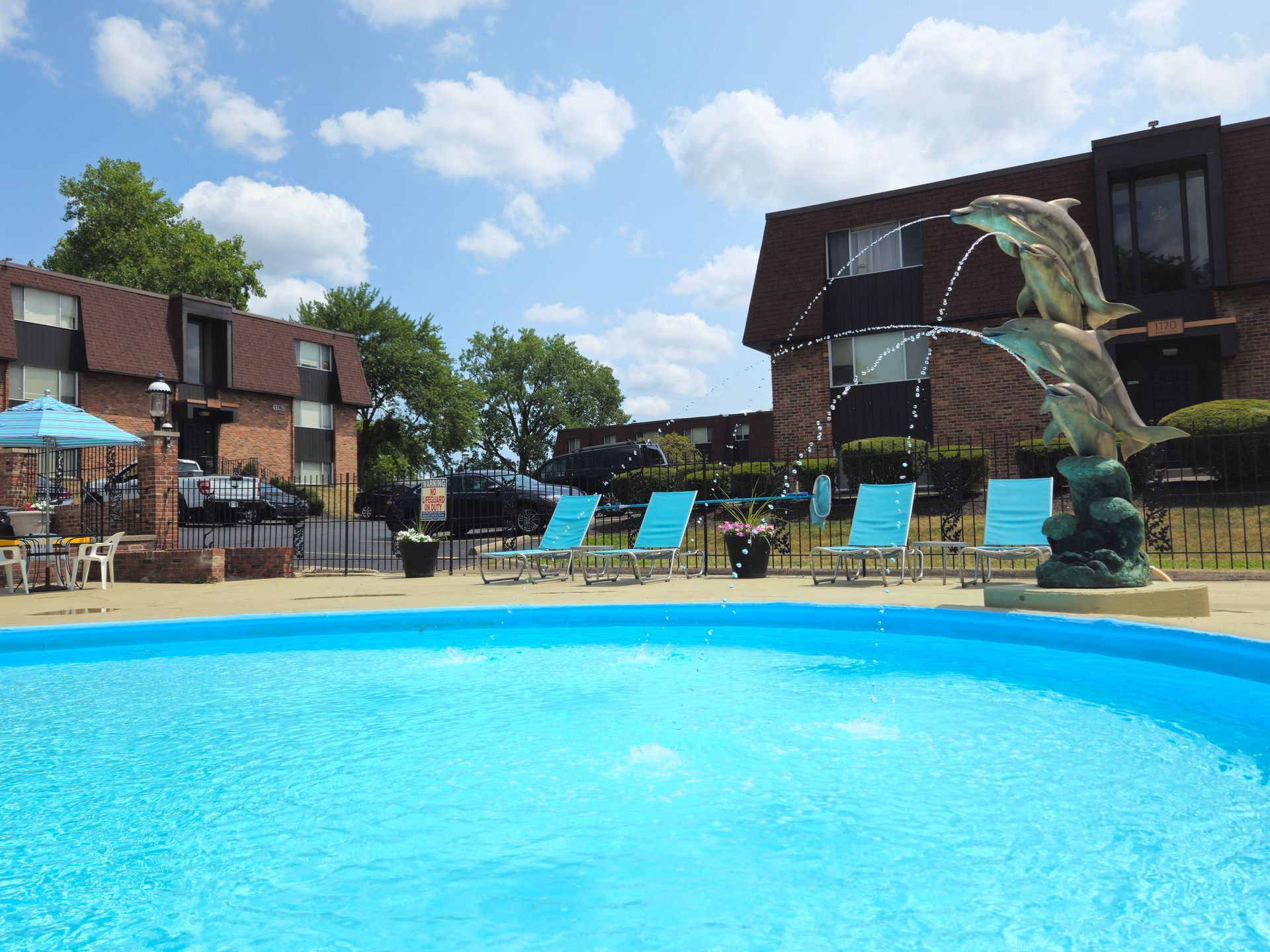 A large swimming pool with a fountain in the middle