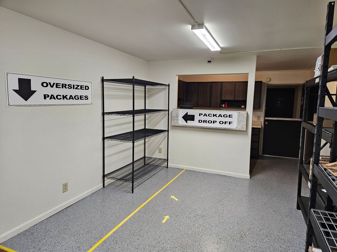 A room with shelves and a sign that says `` oversize packages ''.