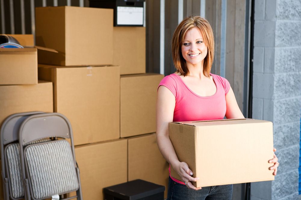 Woman Carry A Box — Storage Aus In Ciccone, NT