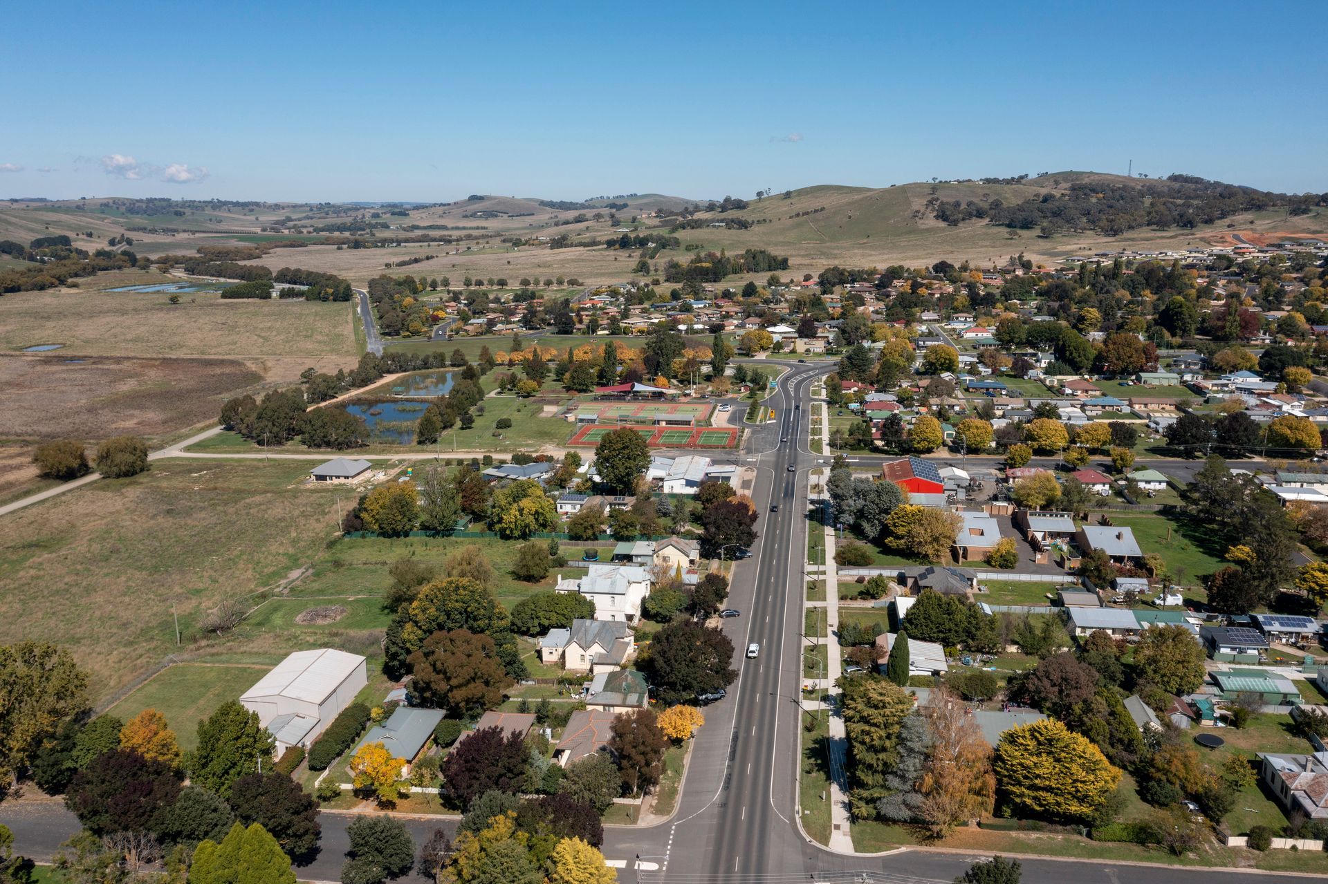Aerial View of a Small Town With a Central Road Lined With Houses — Storage Aus In Cockburn, WA