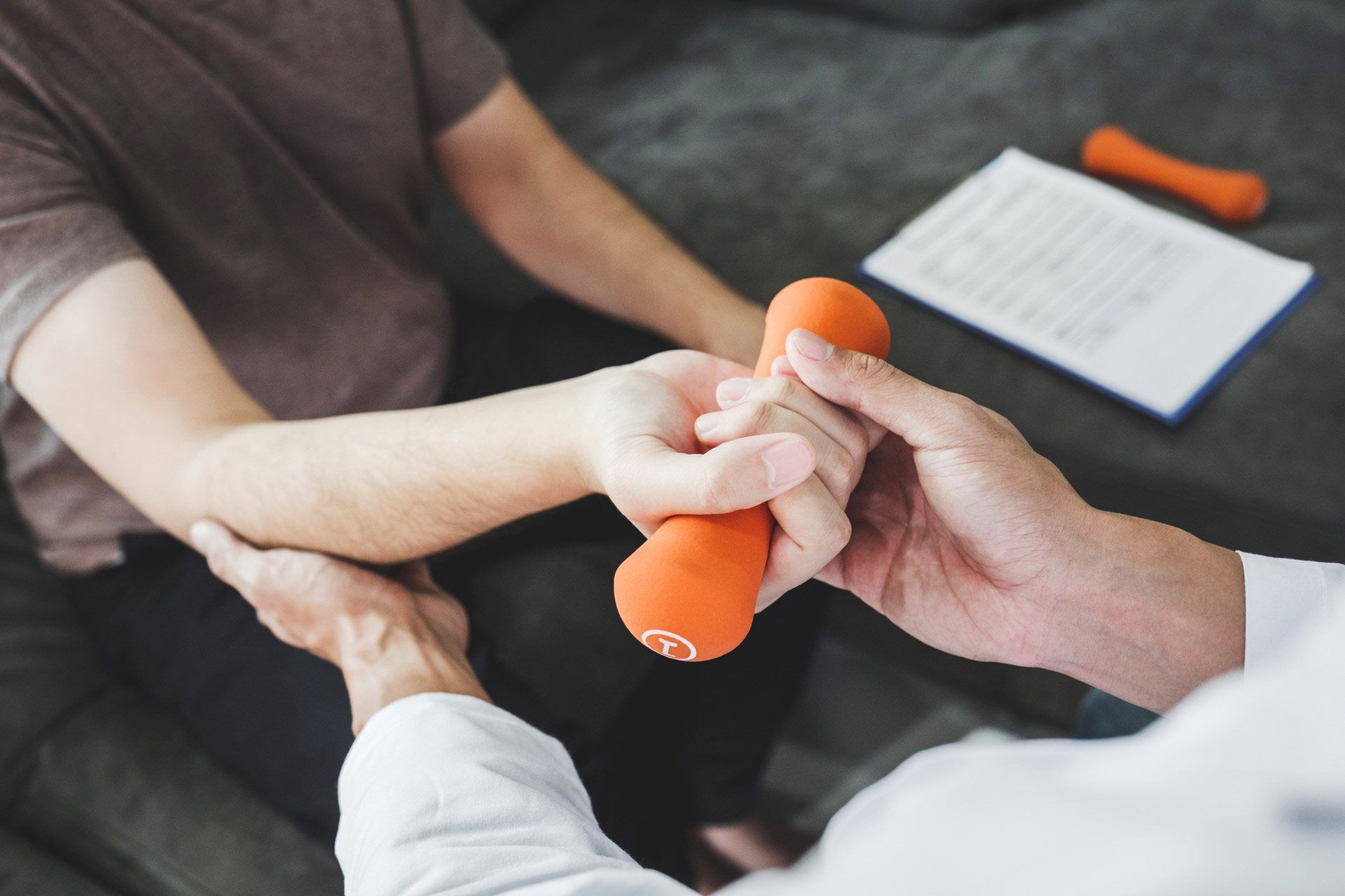 Physiotherapist Man Giving Exercise with Dumbbell Treatment | Dapto, Nsw | Dapto Physiotherapy & Sports Injury Clinic