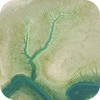 Aerial view of a winding blue-green river cutting through pale green and beige land.