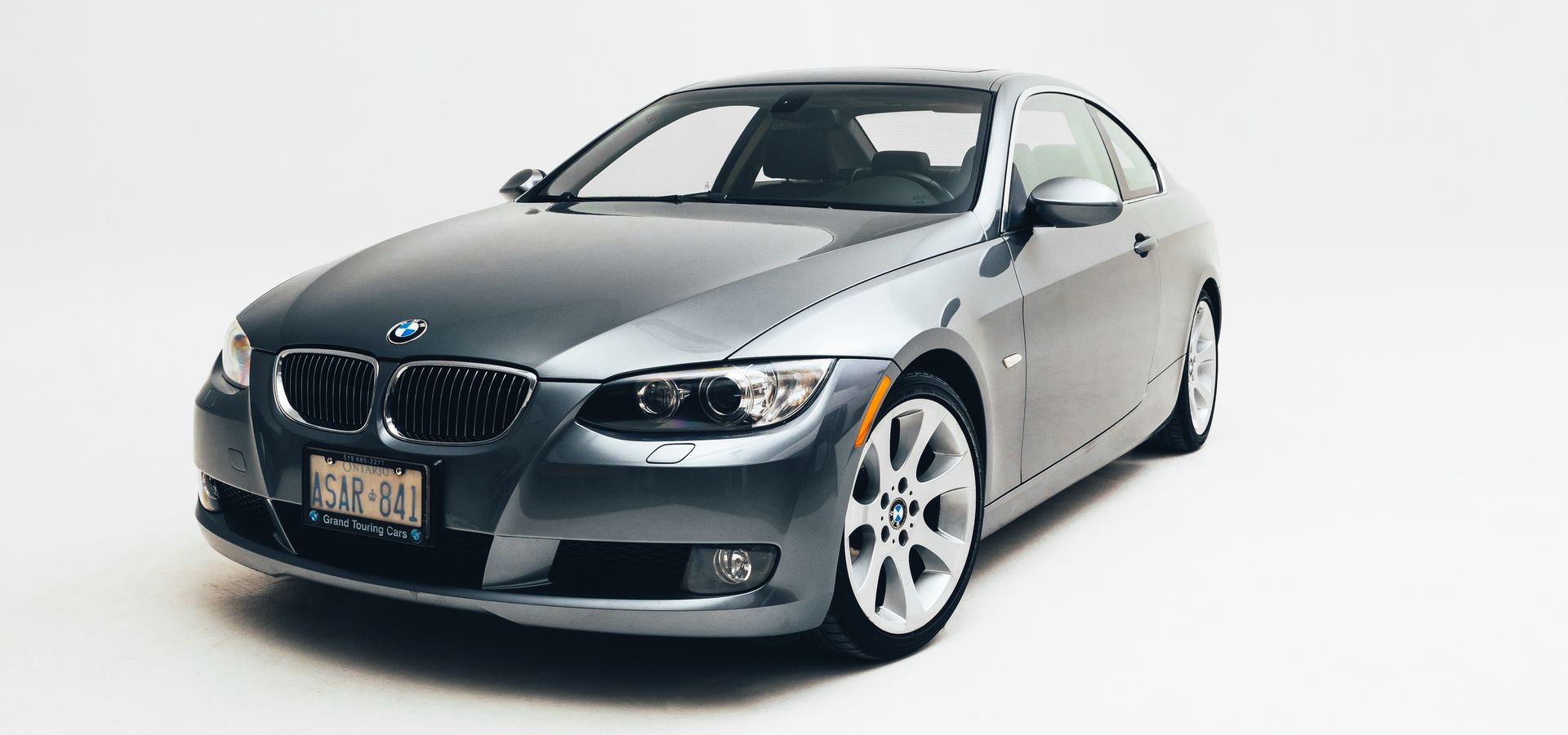 Silver BMW coupe on a white background.