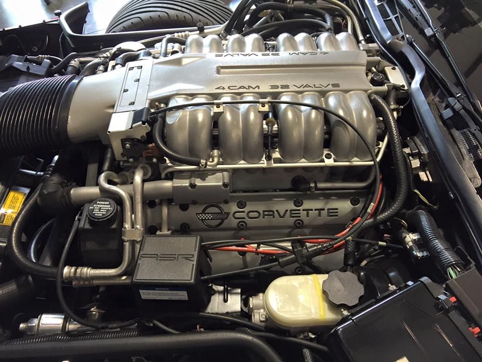 a corvette engine with a lot of wires coming out of it
