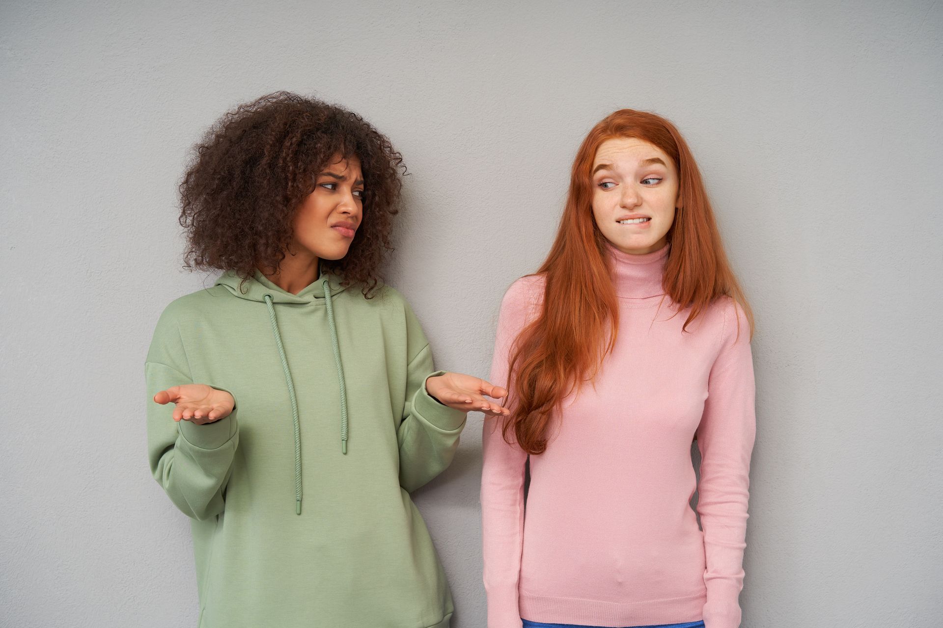 Two women are standing next to each other and making funny faces.