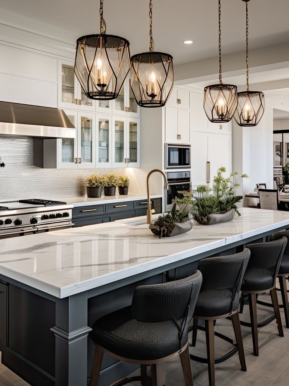 Modern white kitchen with a large island, black barstools, and hanging pendant lights
