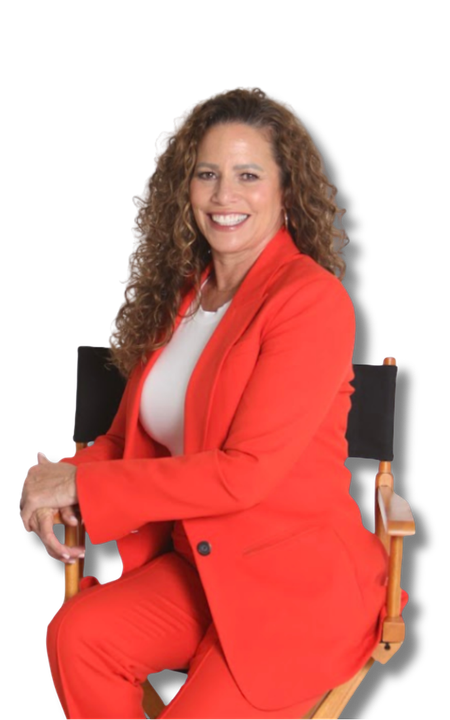 Tina in a black jacket and white skirt is smiling with her arms crossed