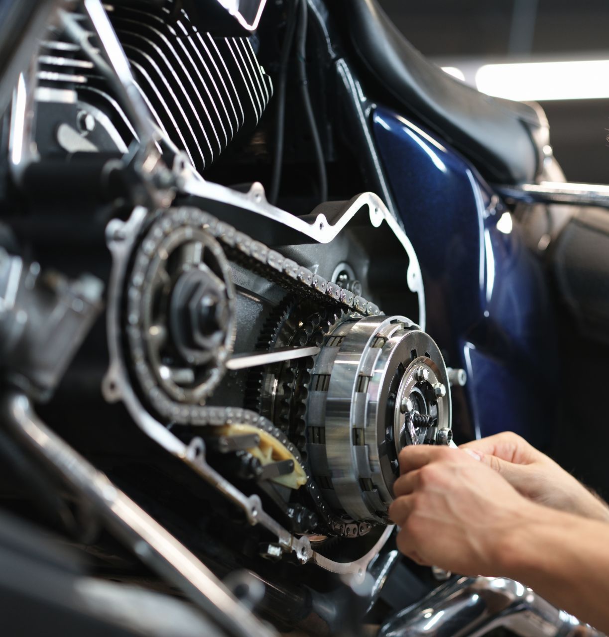 A close up of a person working on a motorcycle